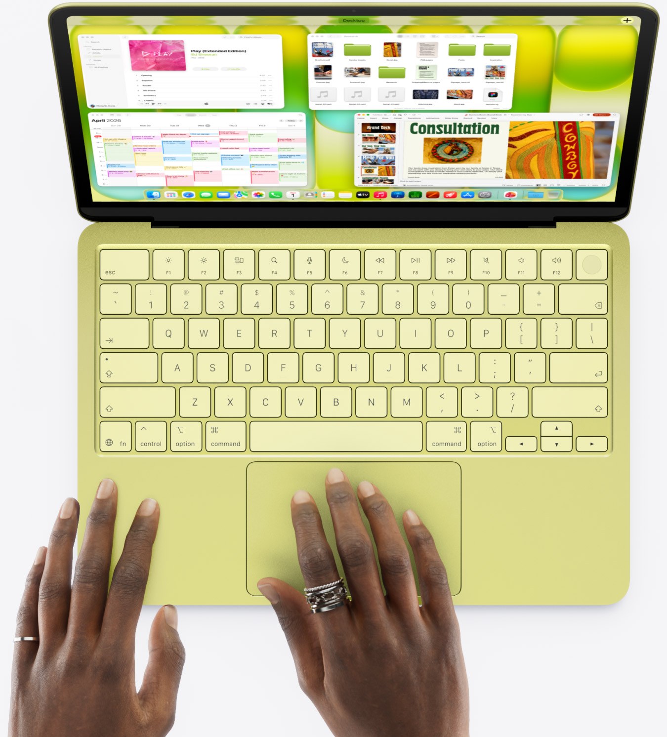 Vue de dessus du clavier du MacBook Neo, mains sur le trackpad